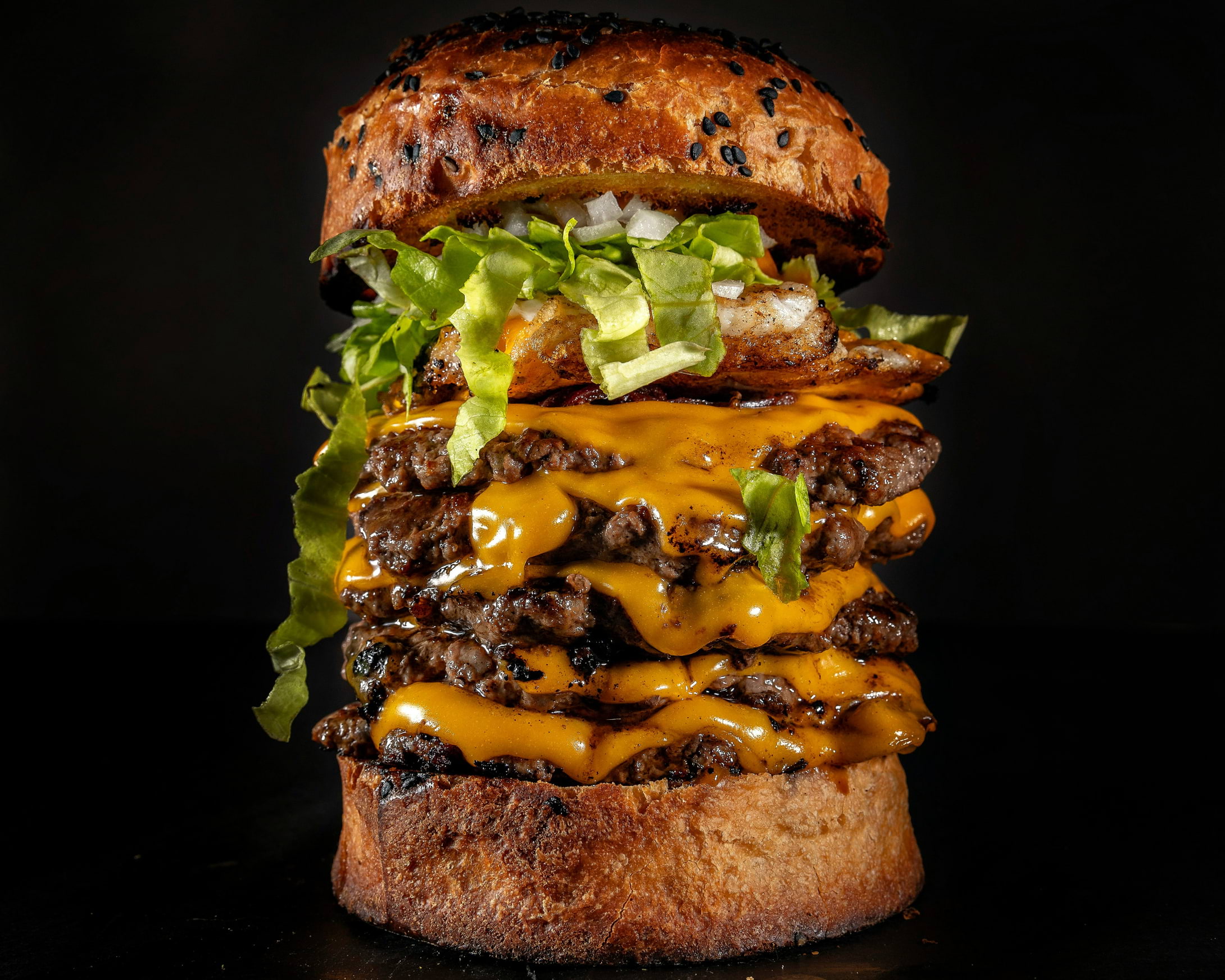 A towering burger with five patties