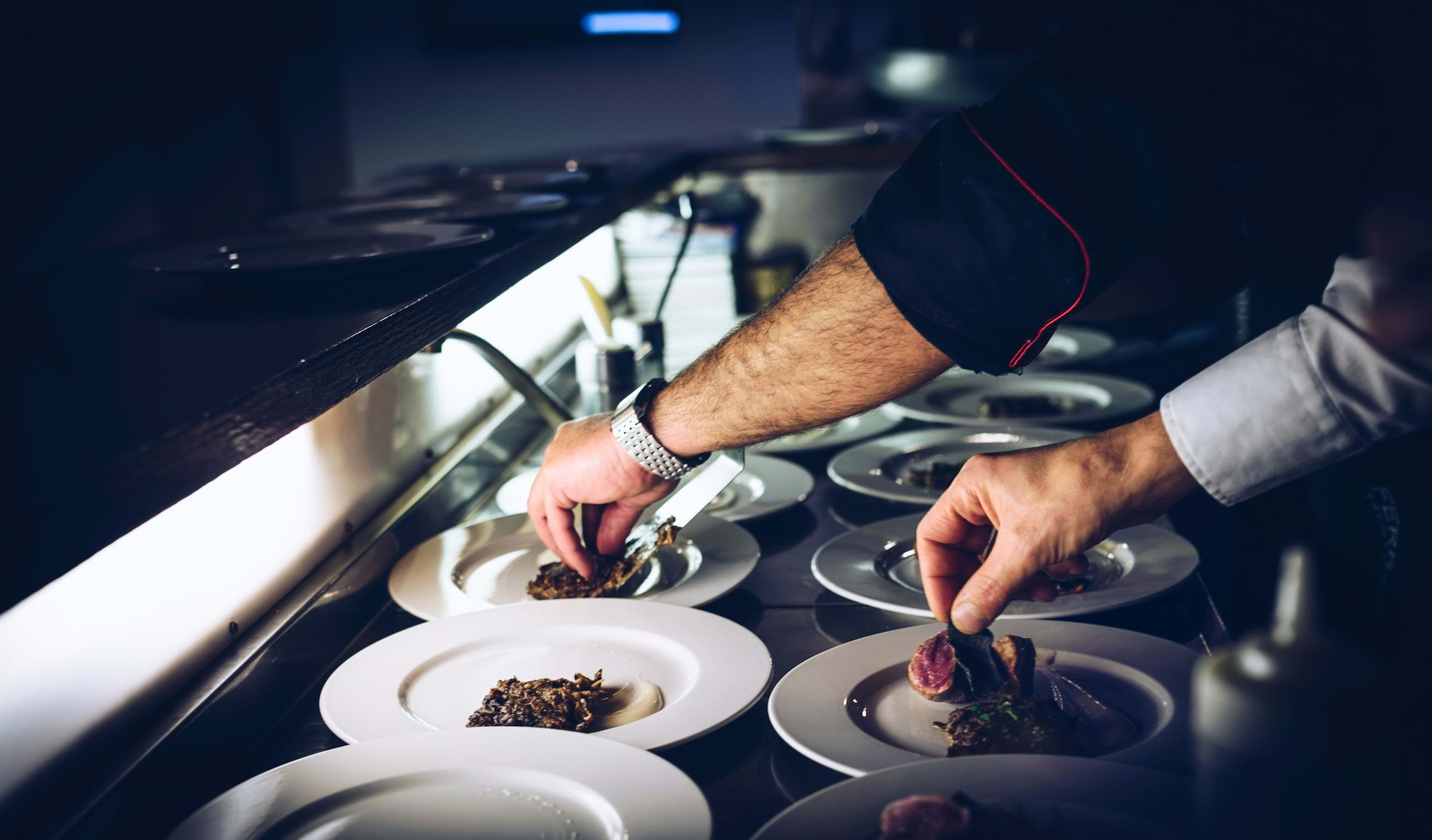 A chef plating dishes in a restaurant