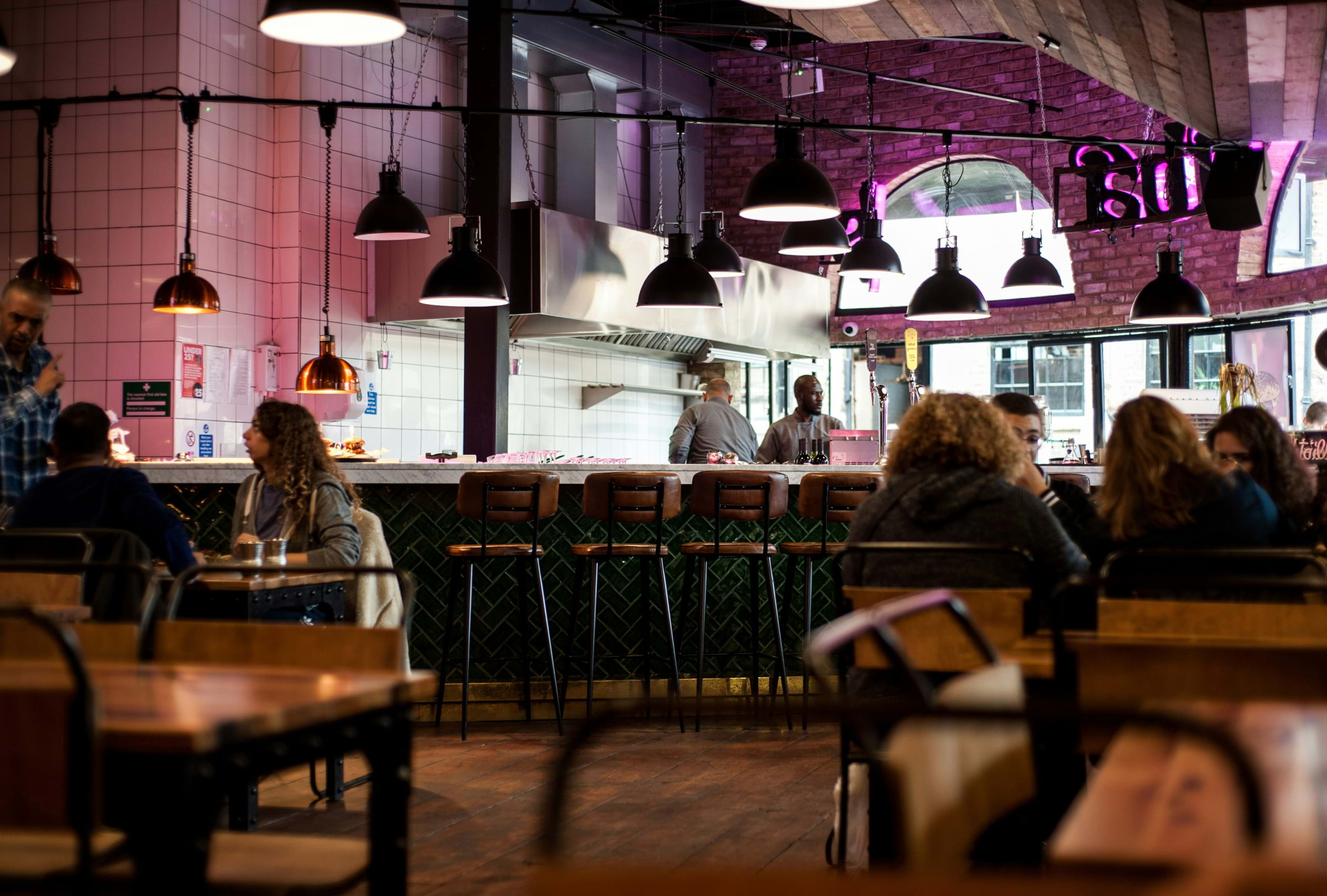 A dimly-lit restaurant with hanging lampshades