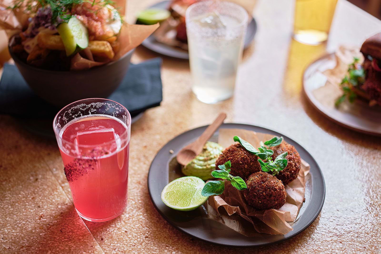 Falafel and other vegan dishes on a restaurant table