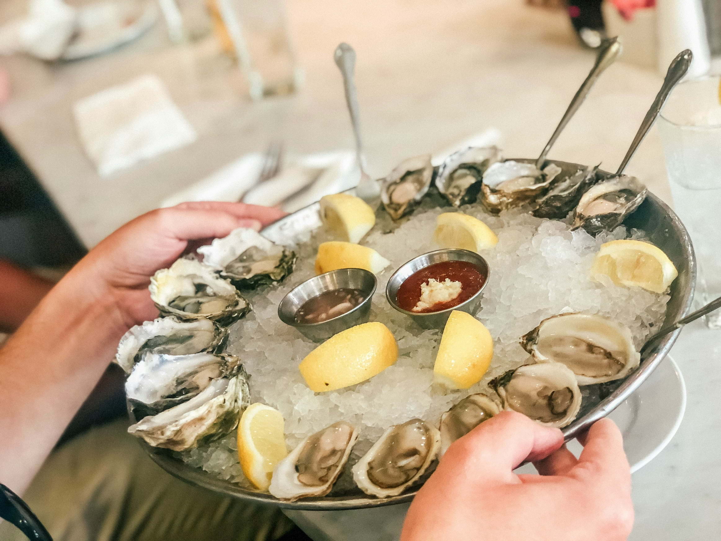 A plate of oysters in ice with lemon