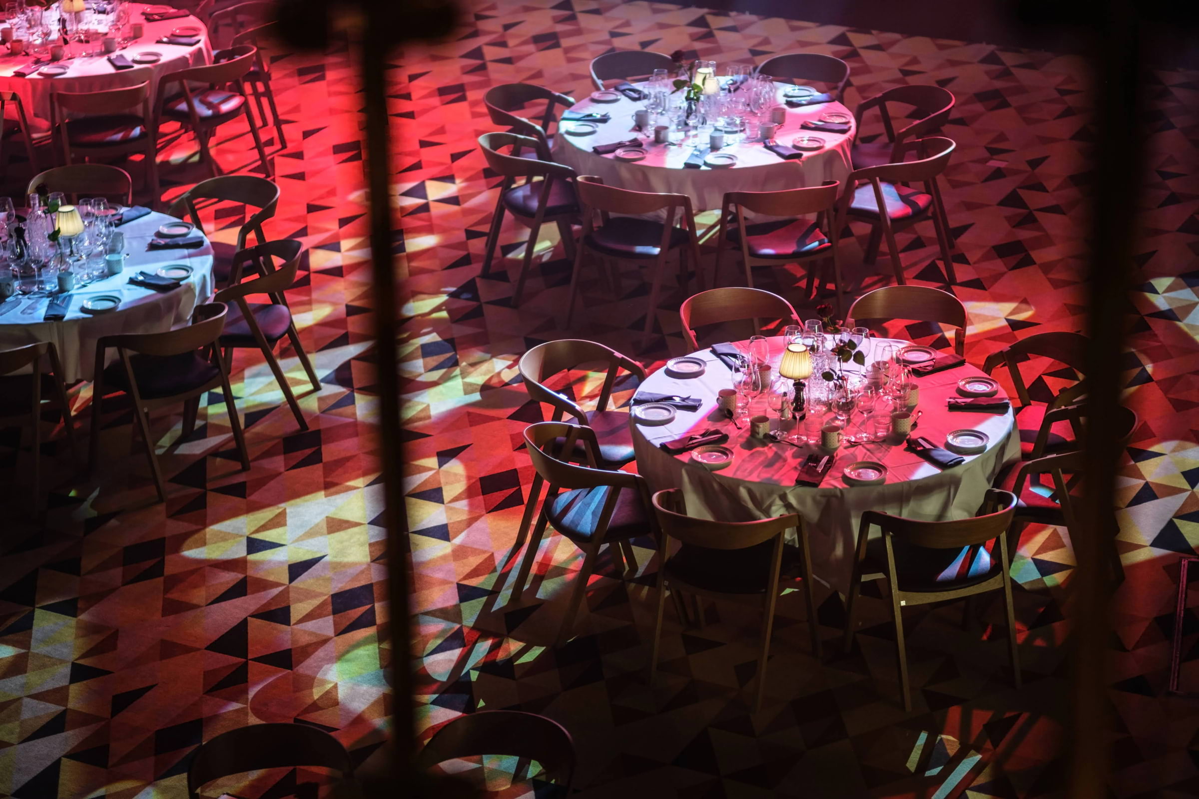 Round tables on a patterned floor in a show restaurant