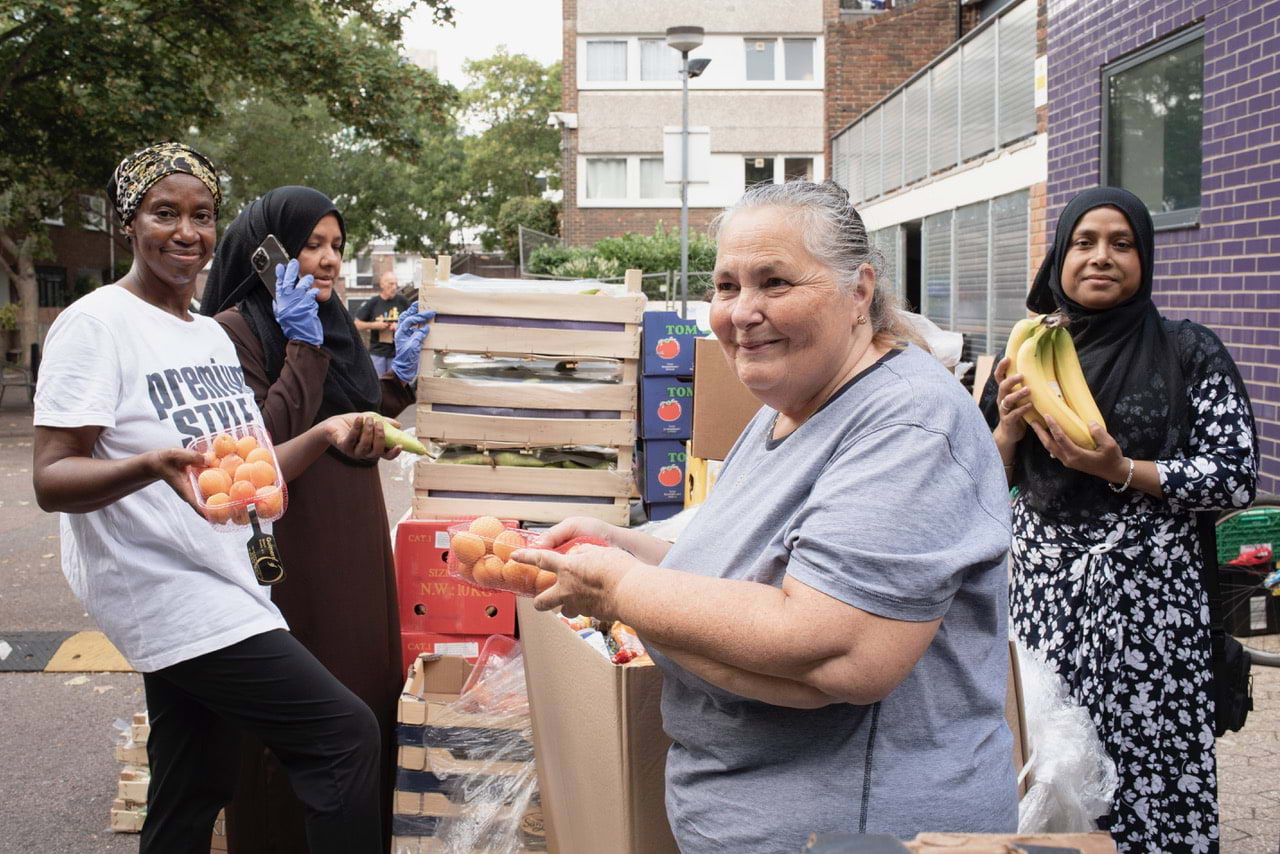 Tower Hamlets Food Bank: (From left to right) Merle Curtis, Sultana Begum, Armagan Middlemast, Husna Begum. From the series Women at Work in Bethnal Green, East London. By Photographer Sarah Ainslie.