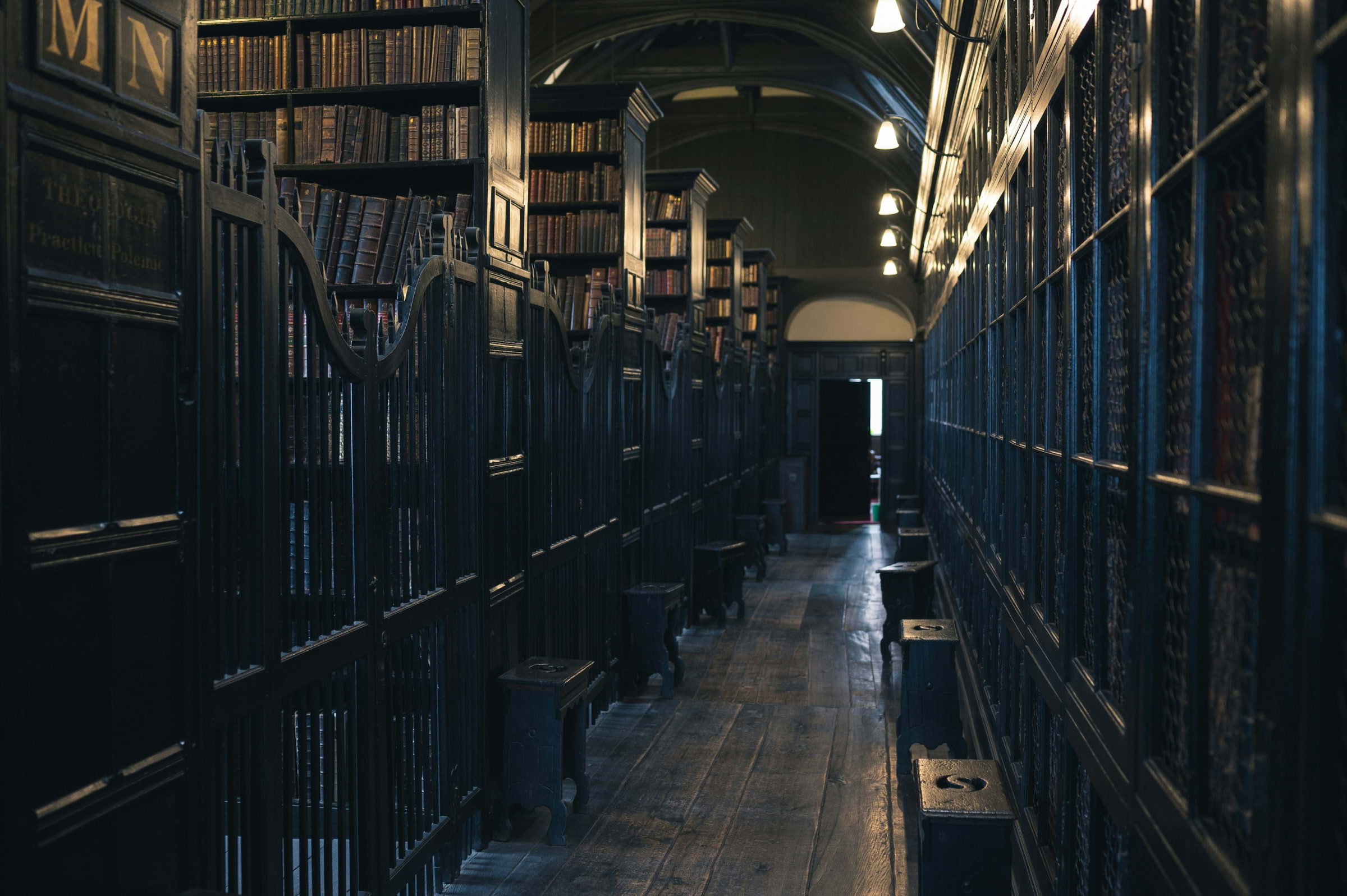 The interior of a library in Manchester with shelves stacked with books