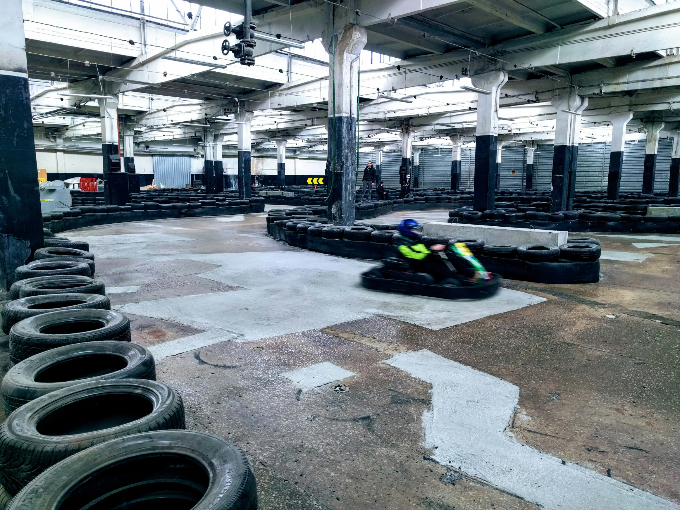 Someone driving around an indoor go-karting track