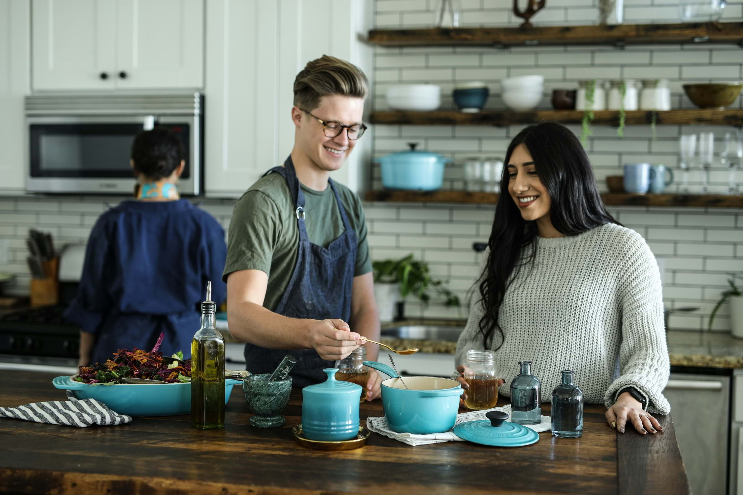 A man and a woman preparing food together in a cooking class