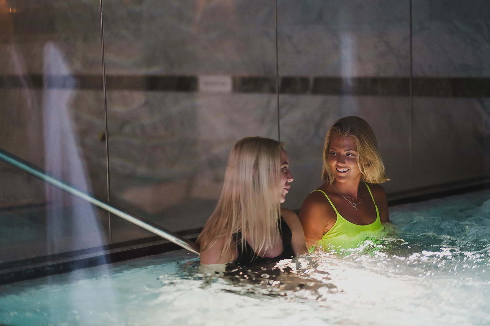 Two women relaxing in a pool