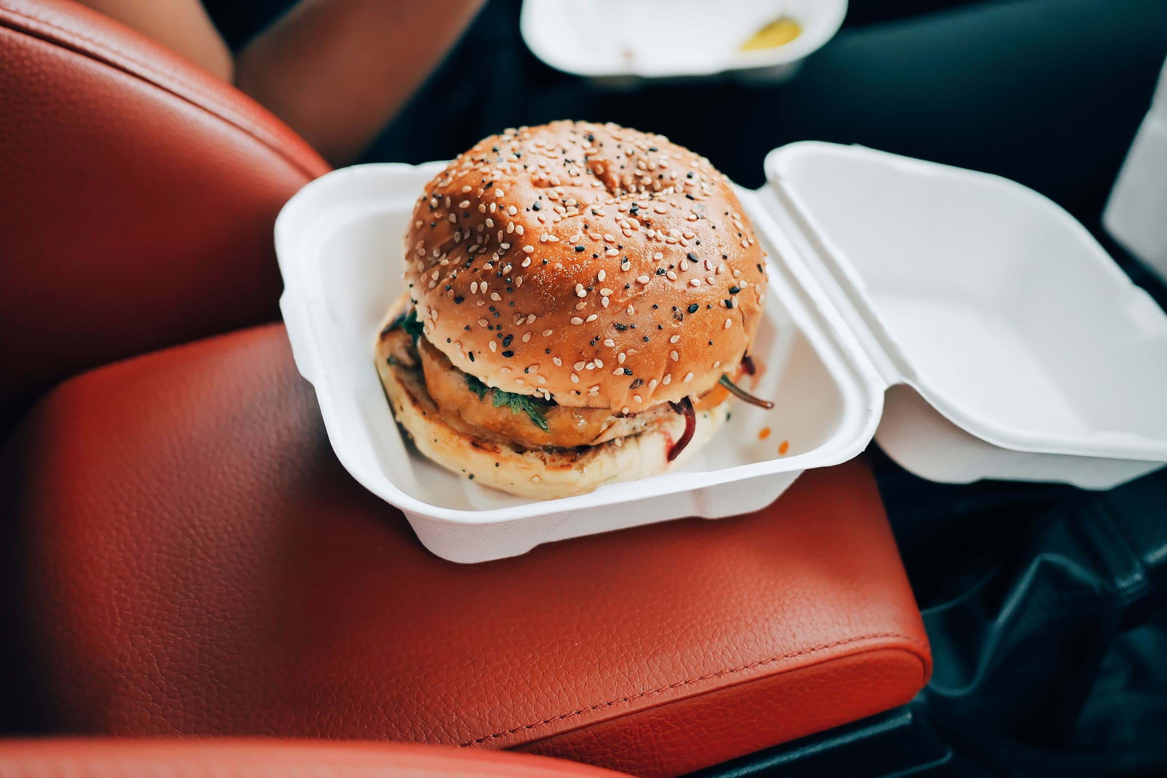 A burger in a takeaway container