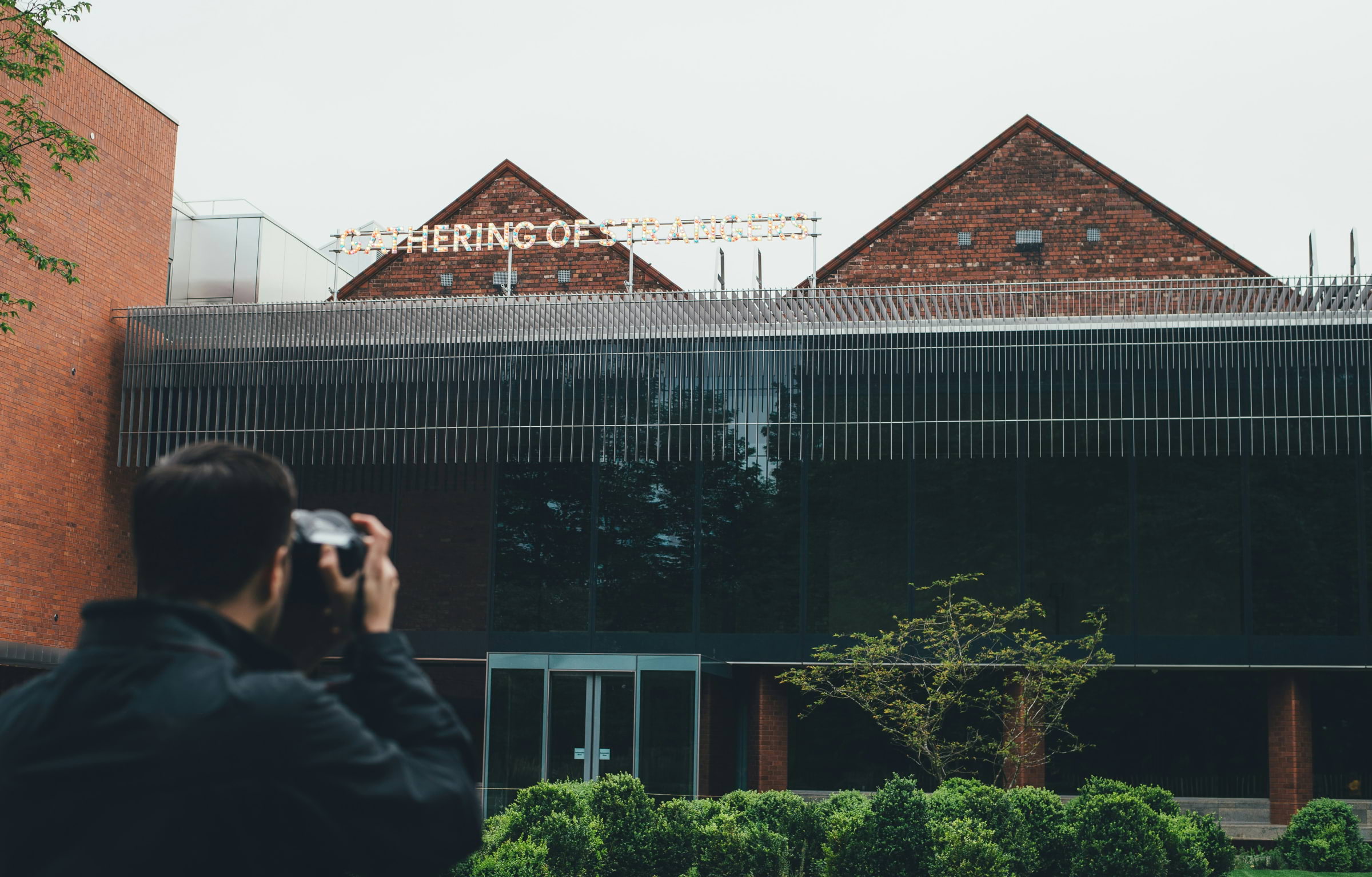 Someone taking a photo of the Whitworth Gallery in Manchester