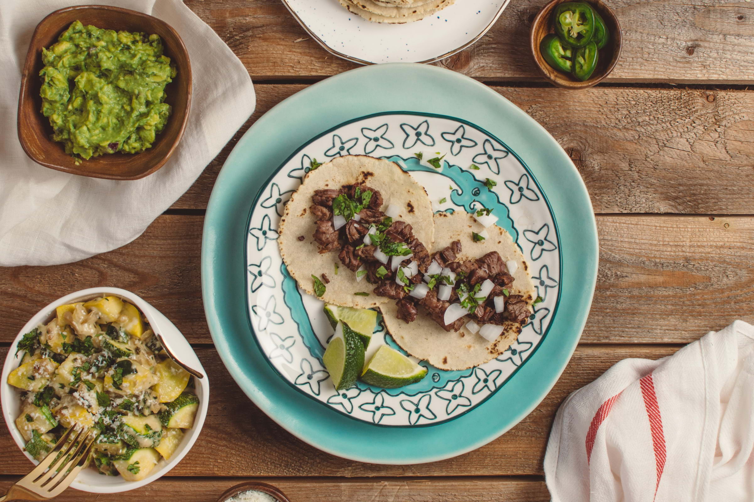 Tacos and guacamole on a wooden table