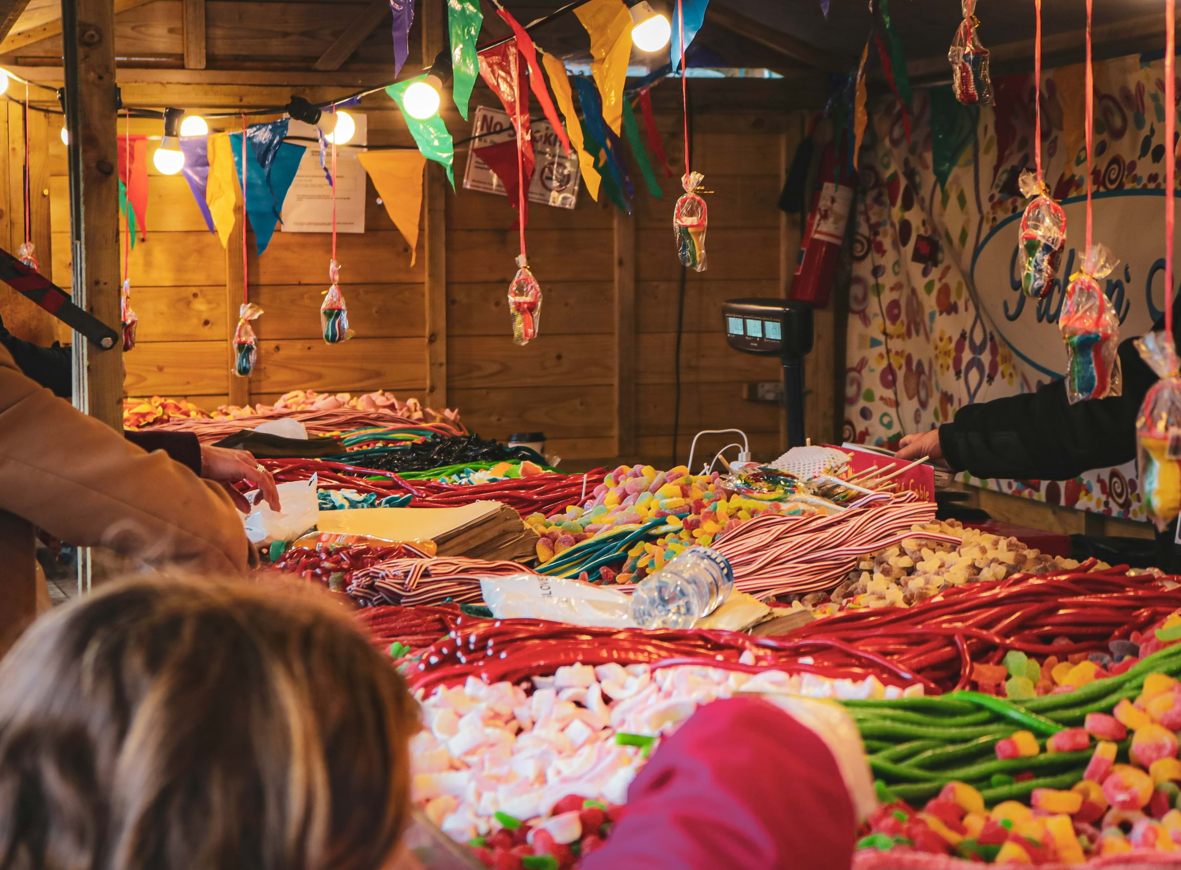 A Christmas market stall with lots of sweets to purchase