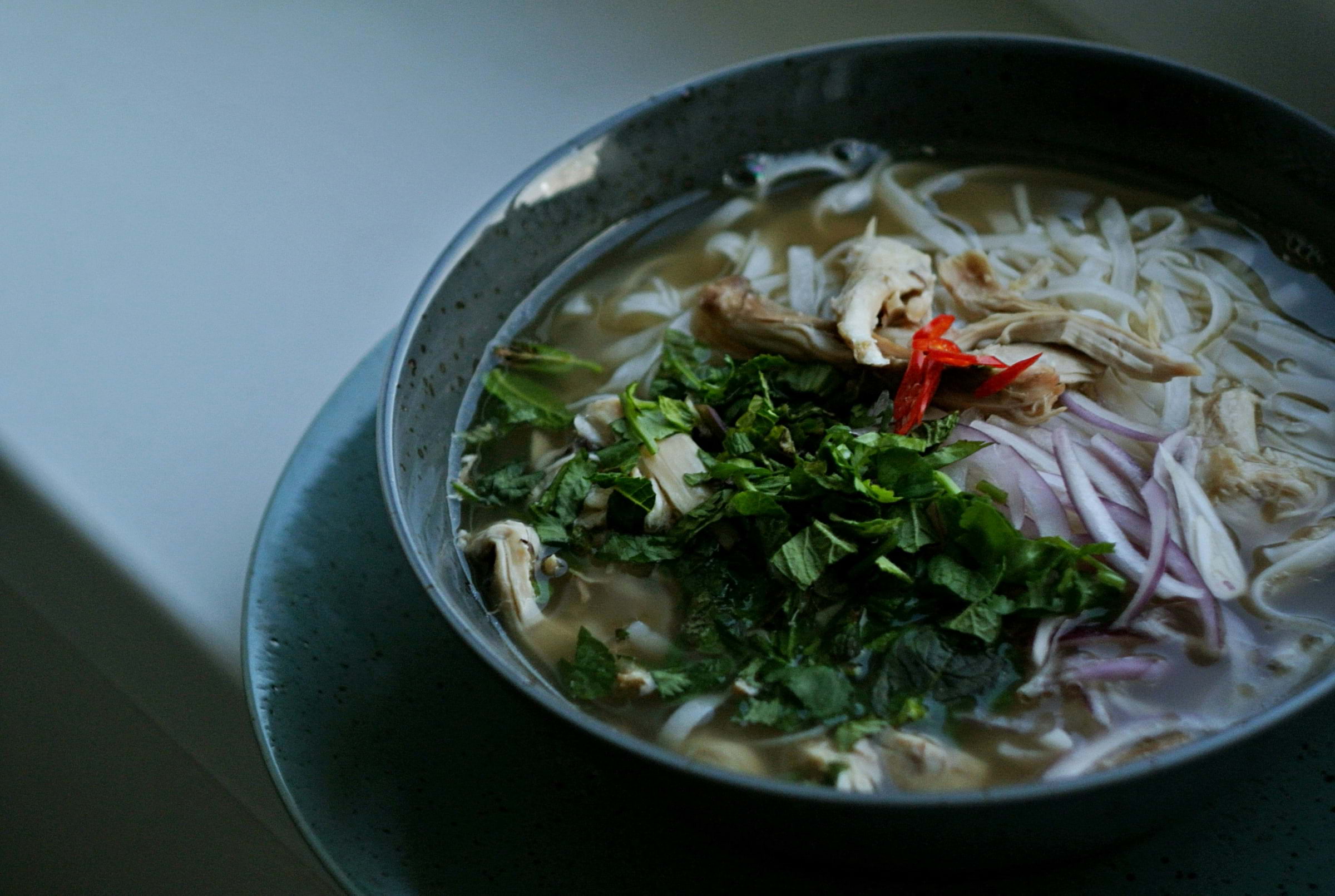 A bowl of hearty pho on a table