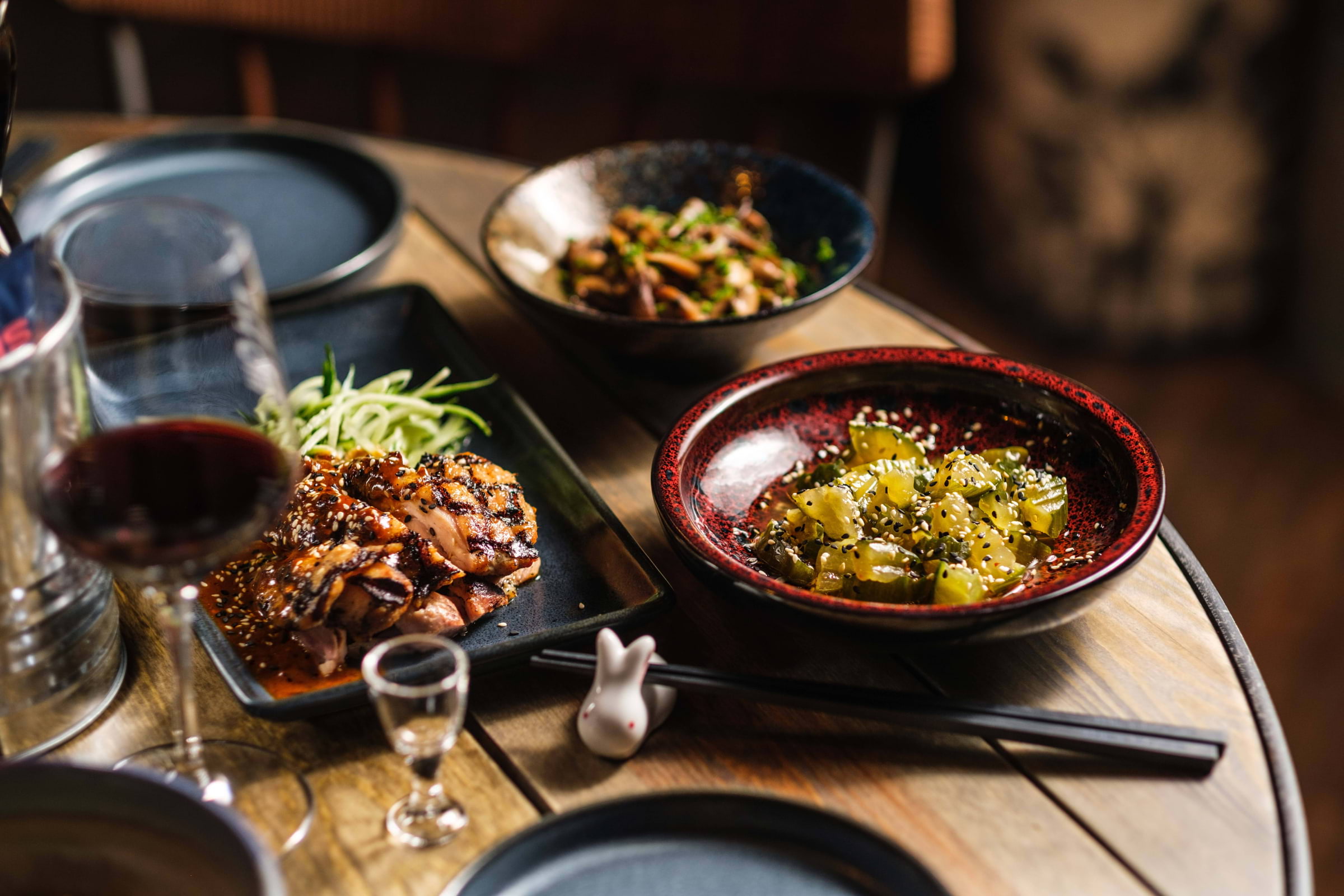 Different dishes set out on a wooden table in a Chinese restaurant