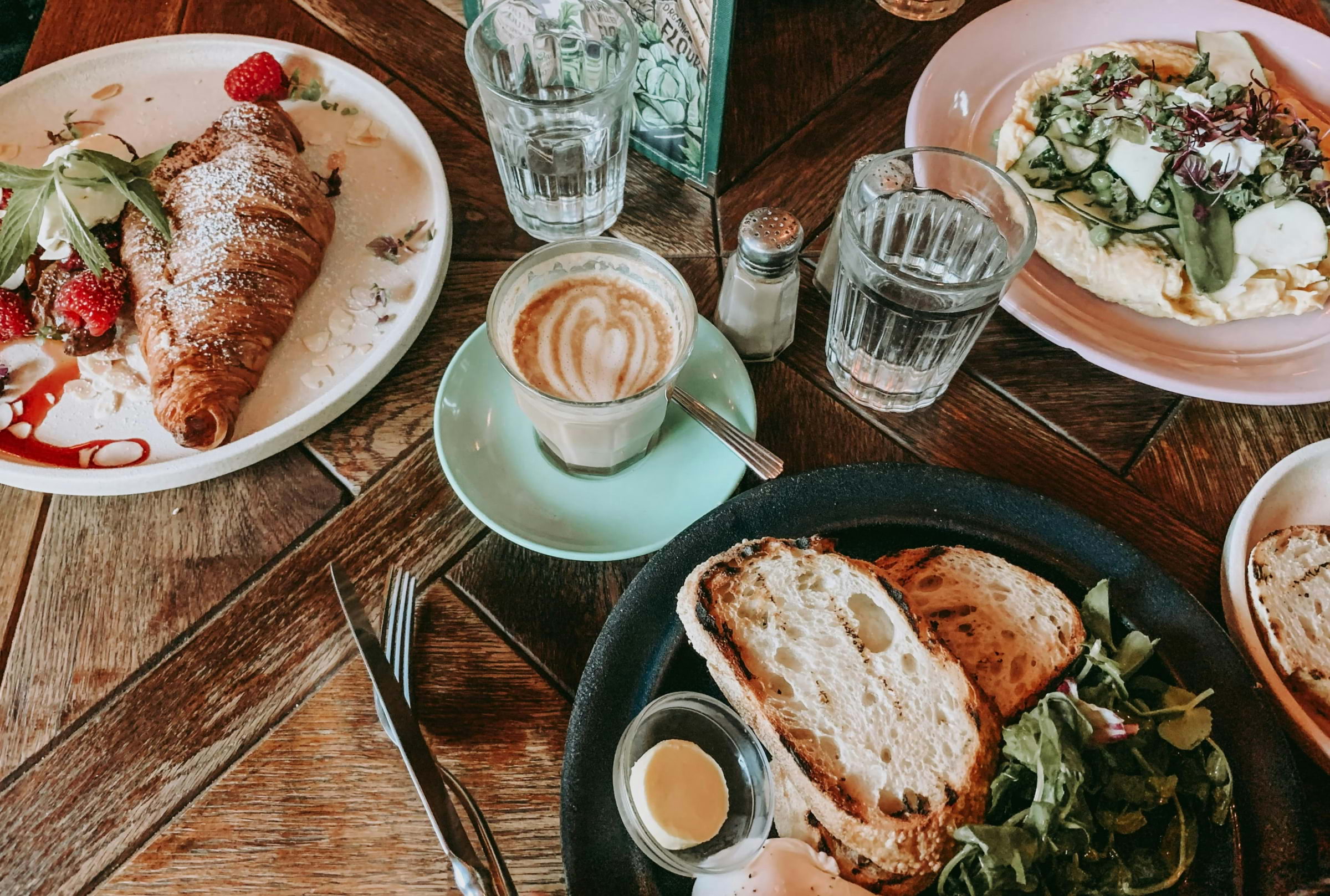A spread of brunch dishes on a wooden table