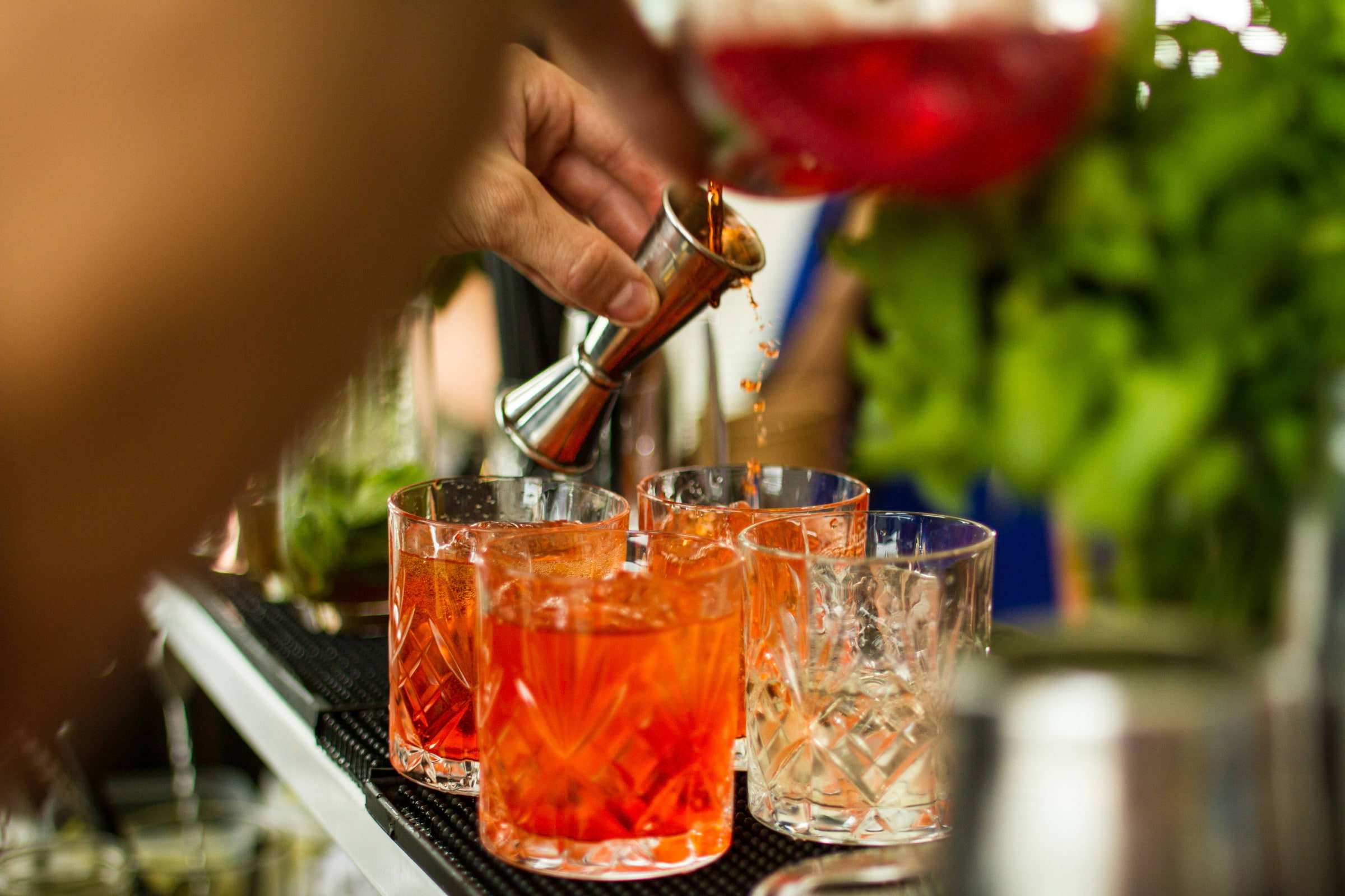 Photo: Someone making negronis on a bar