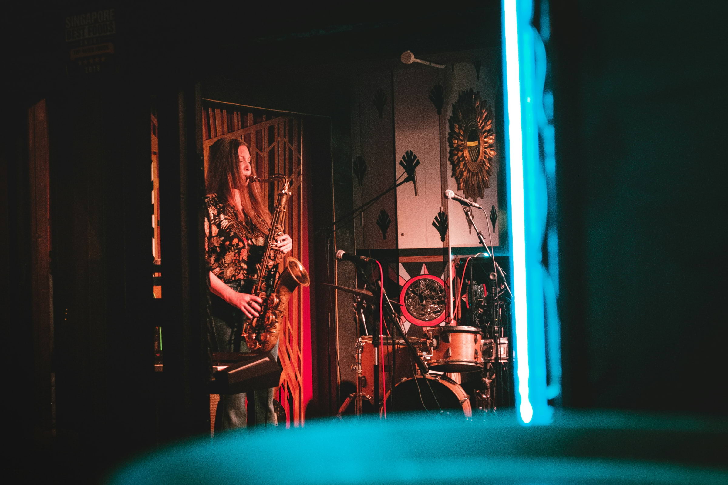 A woman playing the saxophone on a stage