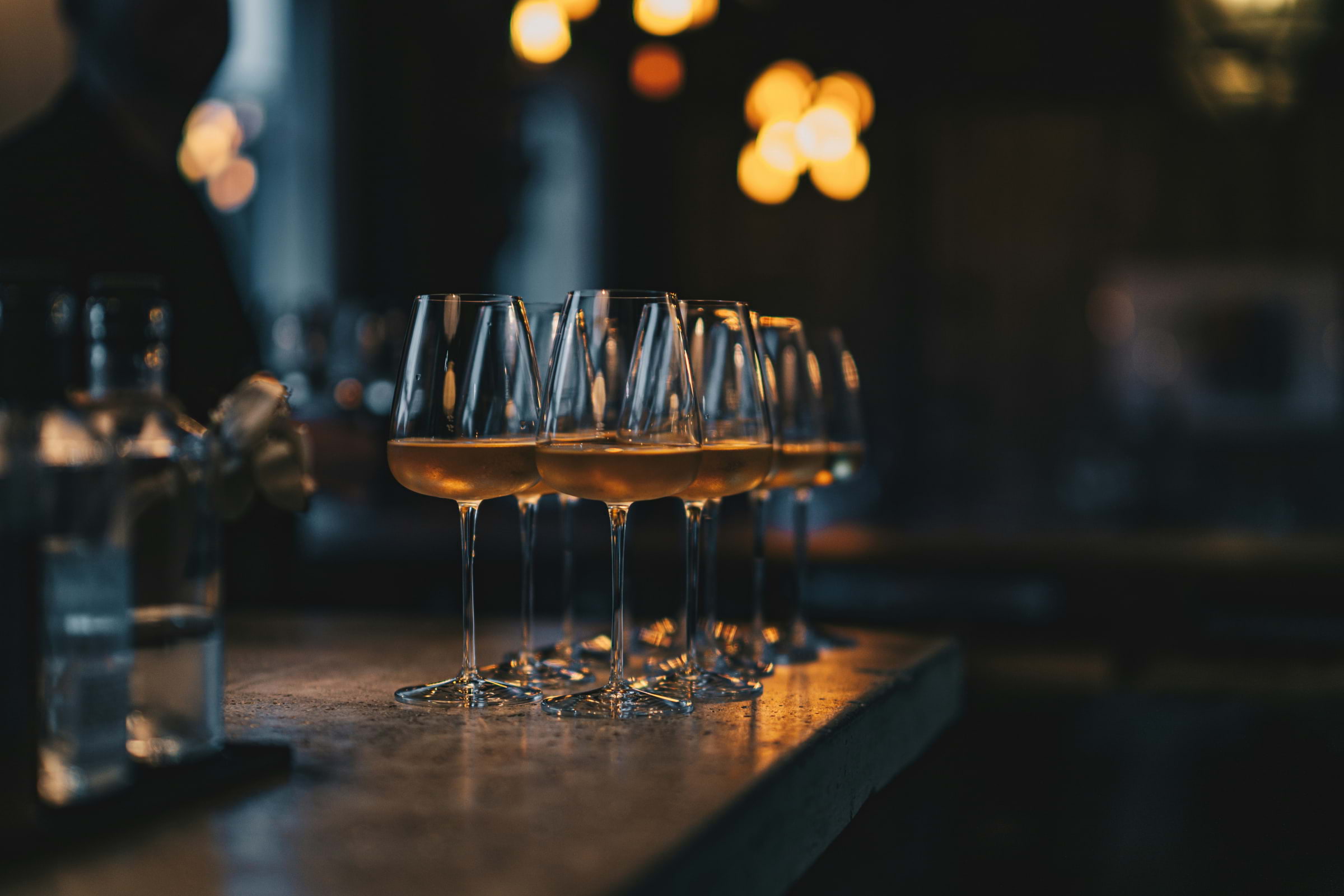 A bar lined with glasses of natural wine