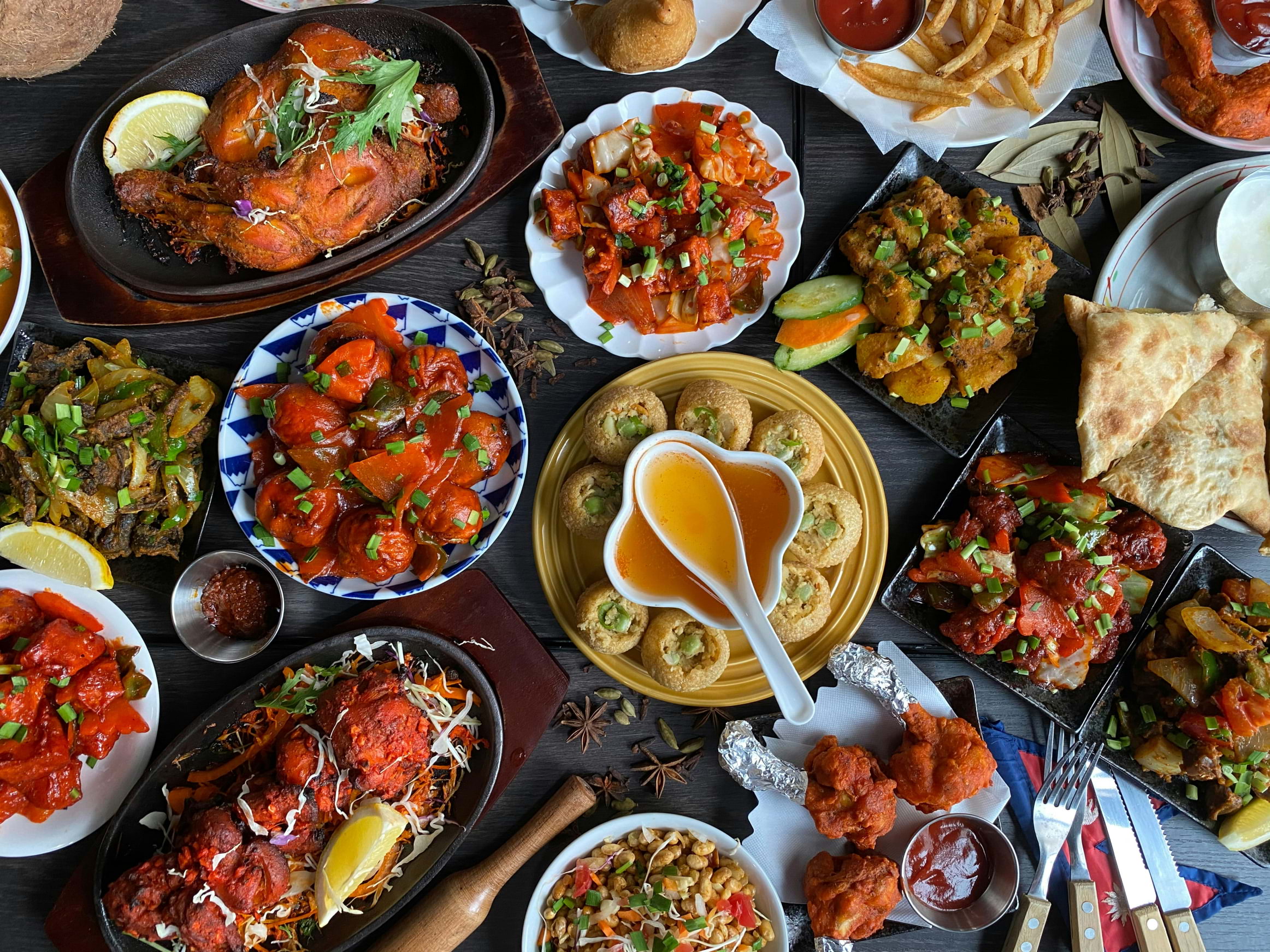 A spread of Nepalese food on a table from above