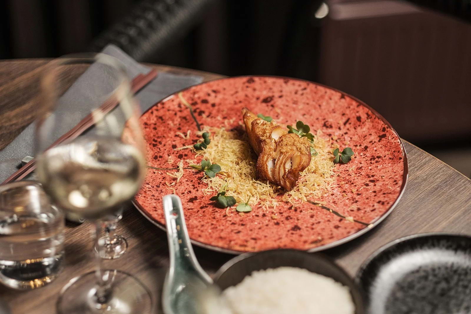 A Chinese dish served on a red plate