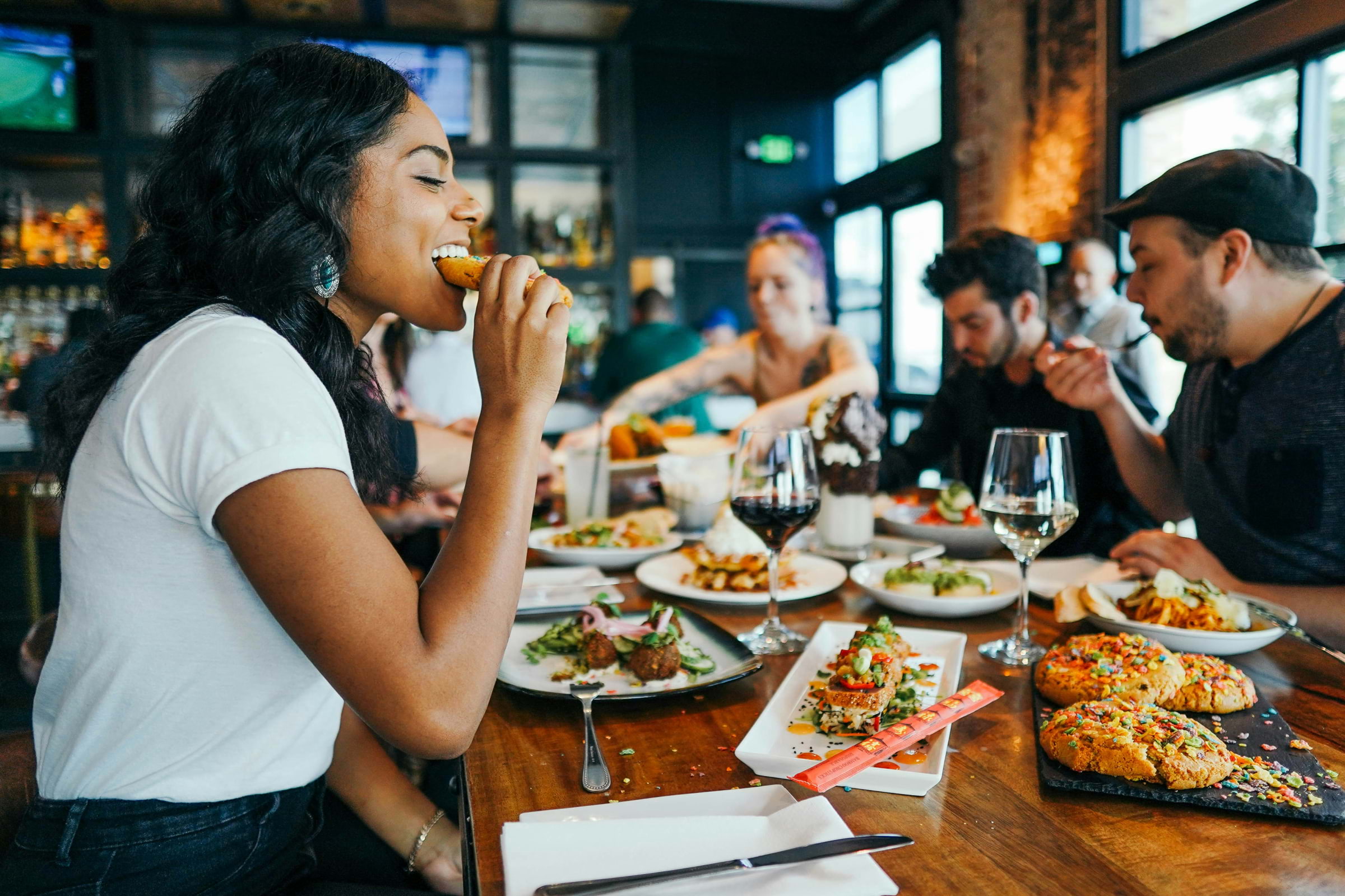 Someon eating food at a dining table with other people