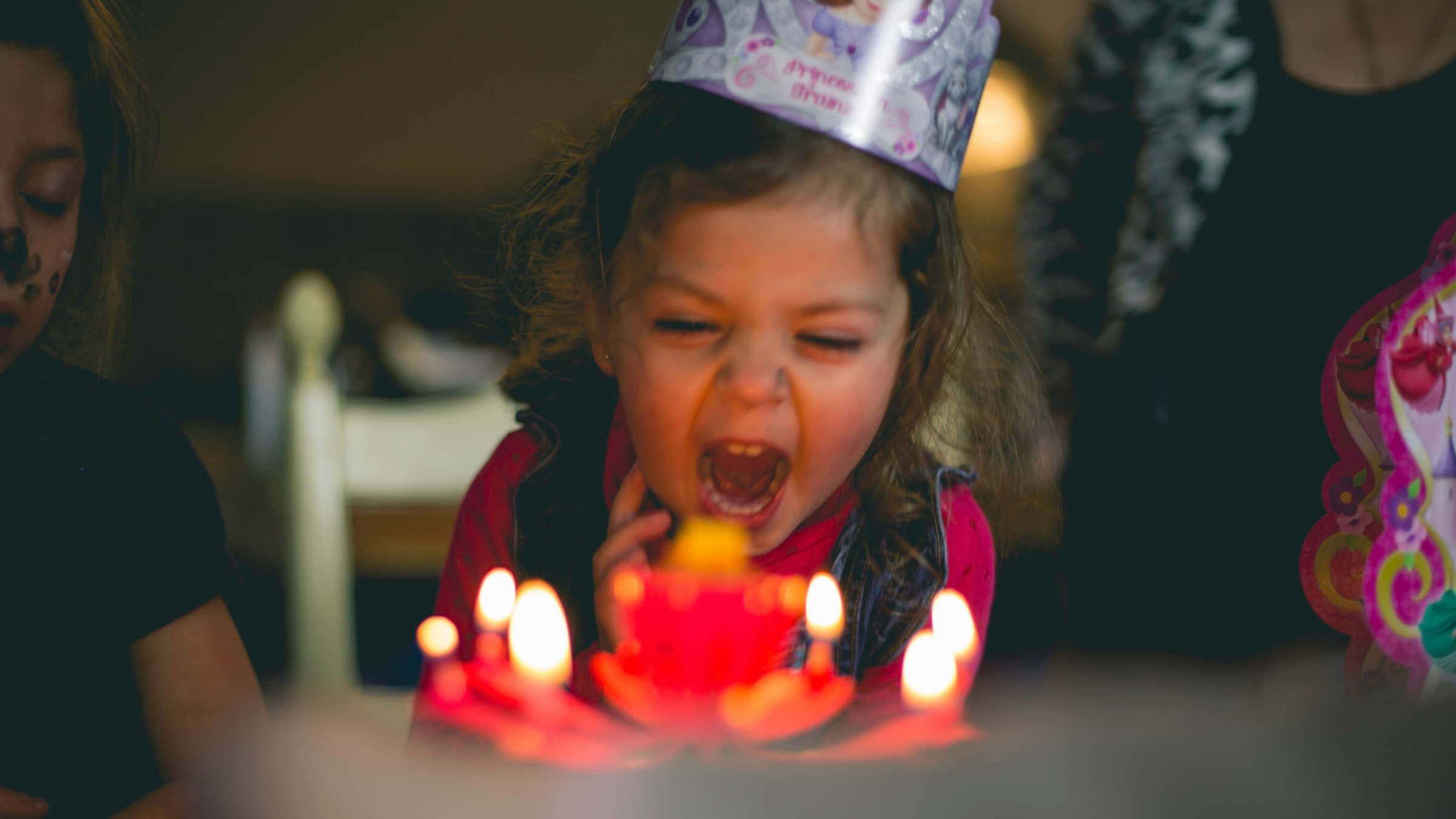 A little girl excited about her birthday cake