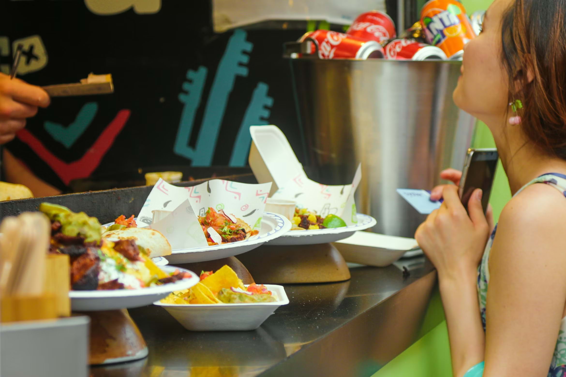 People tucking into plates of chips at a table