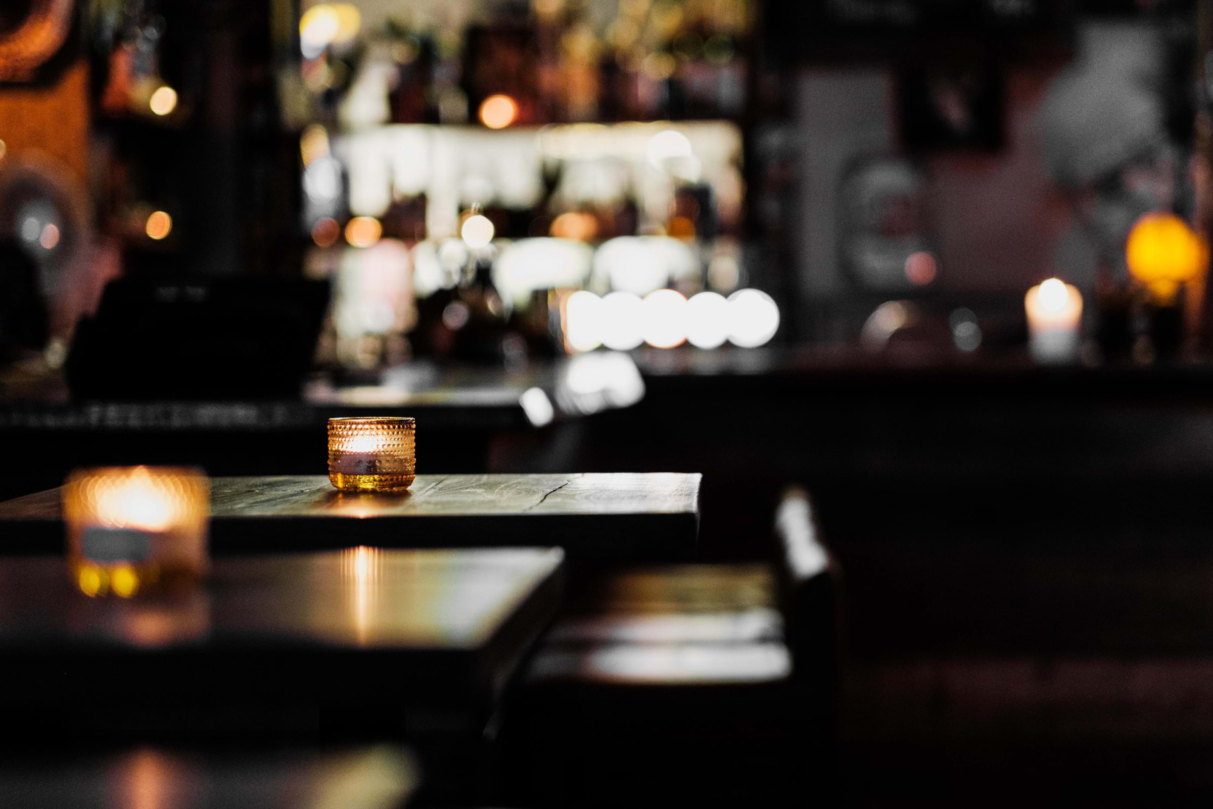 Tealights on tables in a dark bar