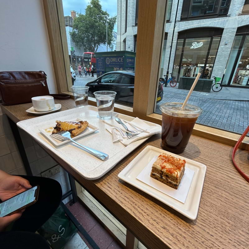 Carrot cake with iced Americano and pommes tart – Photo from Paris Baguette High Street Kensington by Madiha S. (04/08/2023)