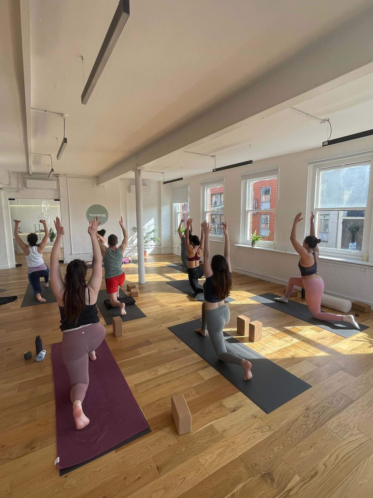 group of people doing yoga  – Bild från Yoga Base av Hayley E. (2024-03-19)